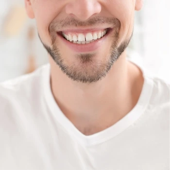 Man with a bright white smile after teeth whitening