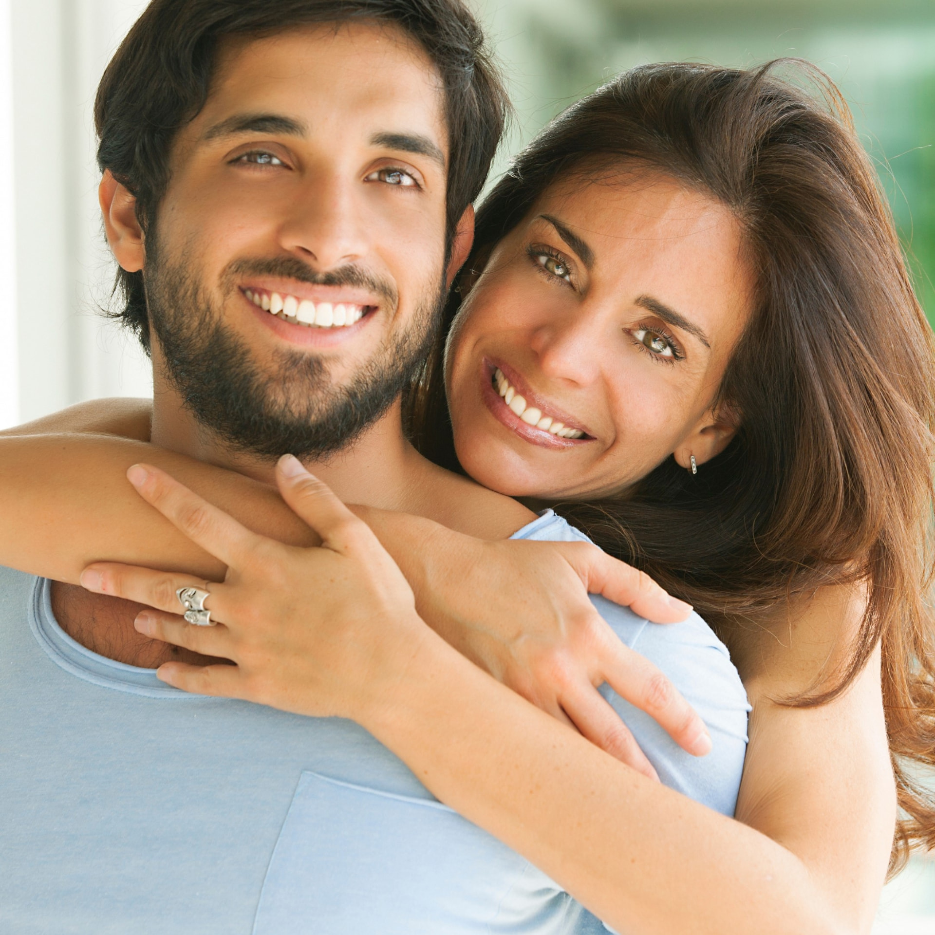 Happy couple smiling after judgment-free dental care in Shepperton