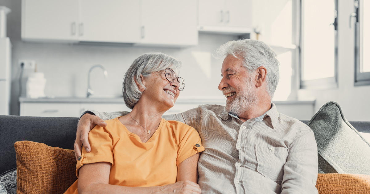 Happy older couple laughing together after Teeth In A Day in Shepperton