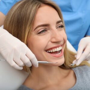 Woman brushing her teeth after reading dental tips in Shepperton

